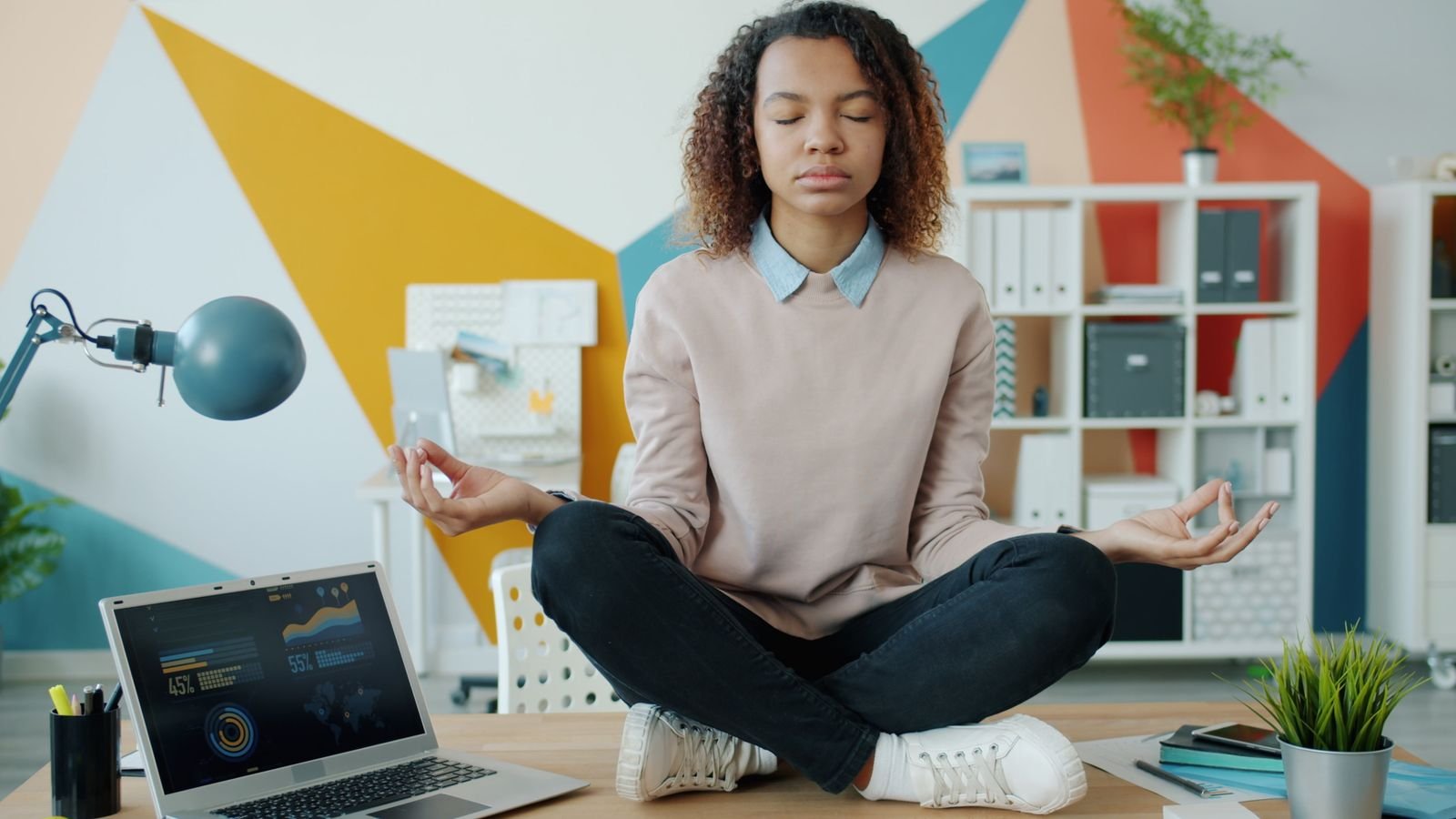 Working professional practising a breathing break at a desk