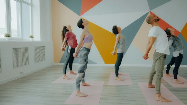 Group working through an active yoga sequence