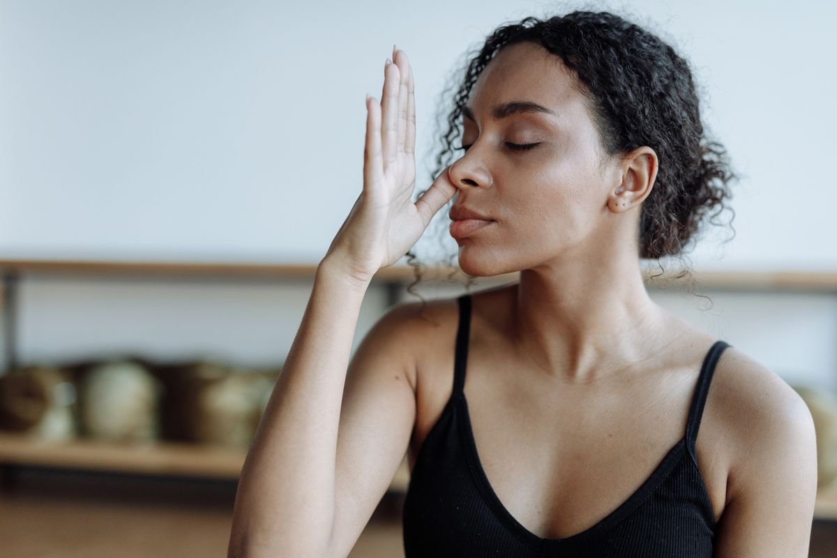 Alternate nostril breathing during a pranayama class in Baner
