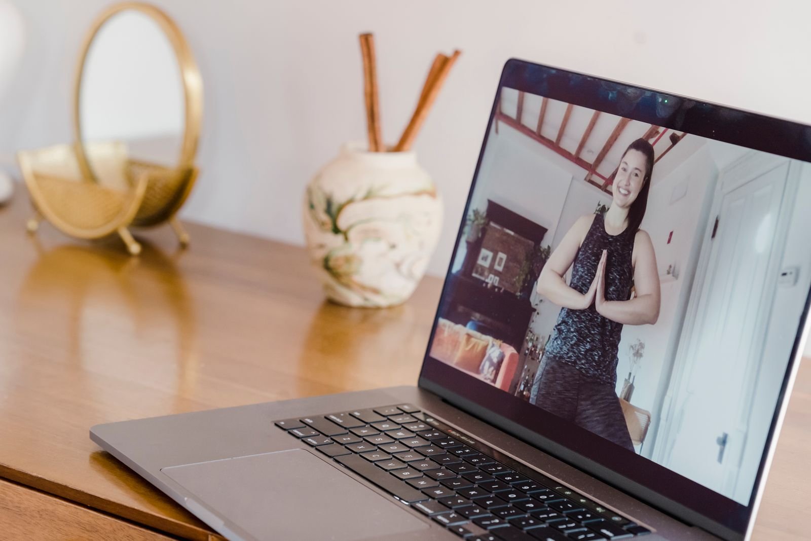 Student joining a live online yoga class on a laptop
